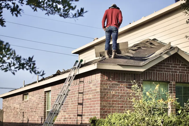 Professional roofer working on a residential roof in Southtown